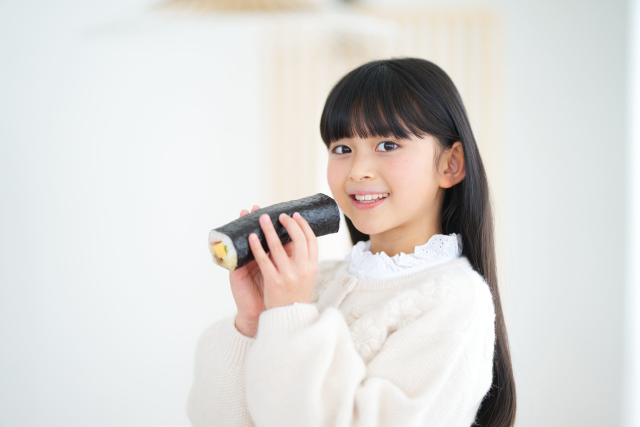 恵方巻きを持つ女の子